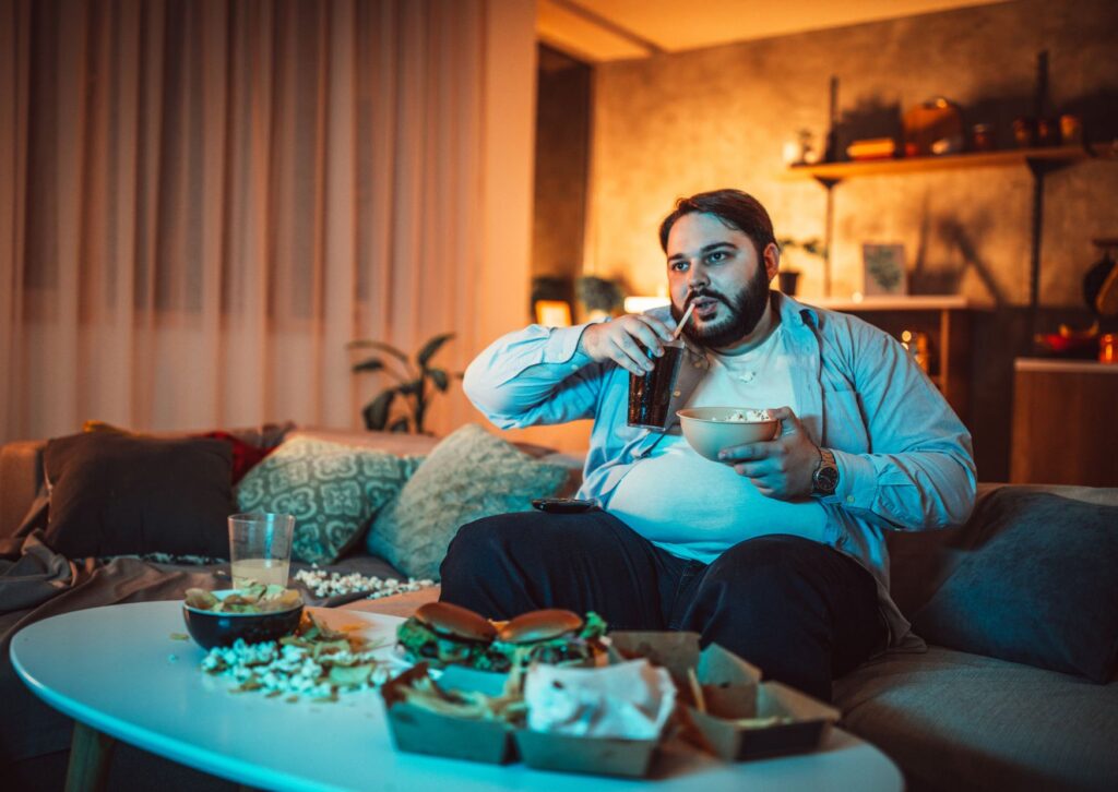 fat-man-eating-on-the-sofa