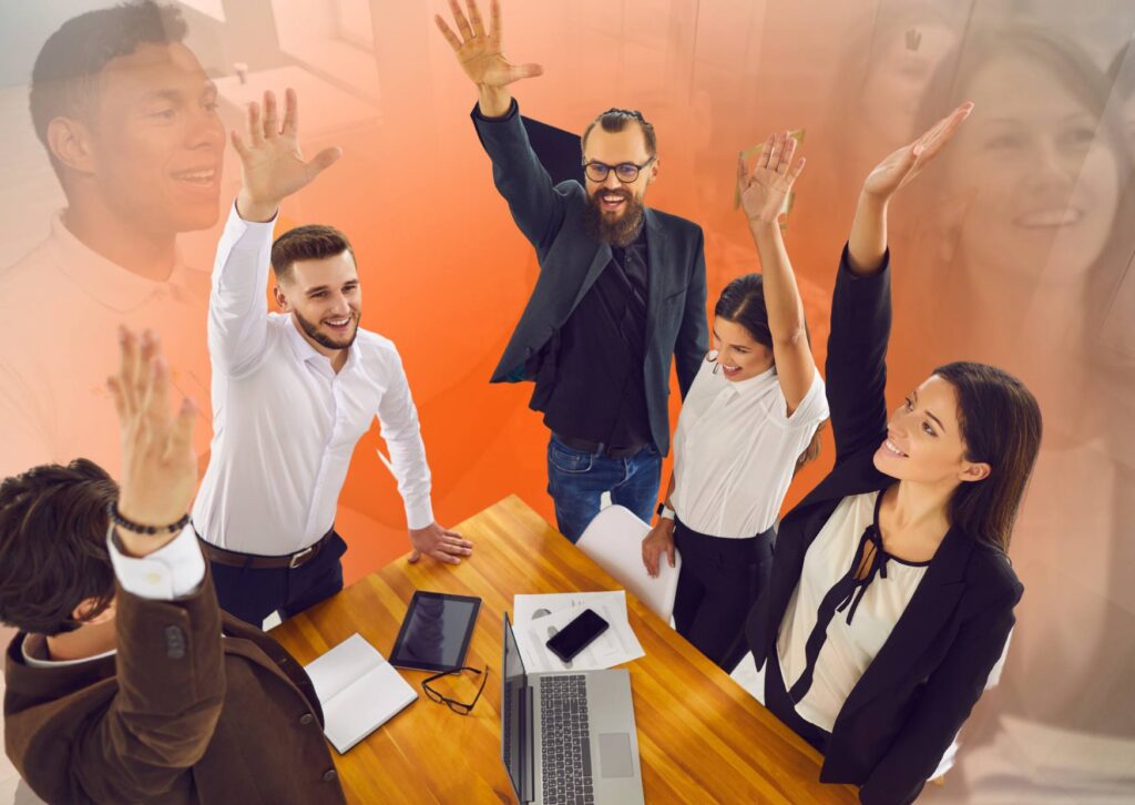 happy-staff-in-an-engaging-team-meeting-with-hands-in-the-air