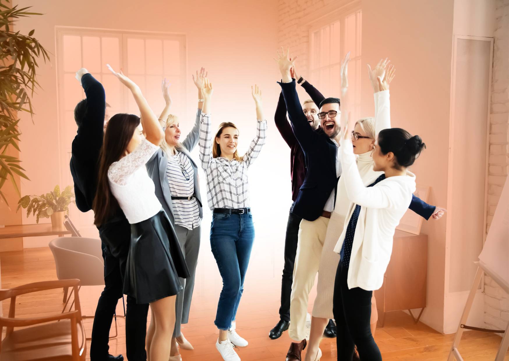 team-at-work-having-fun-wiht-hands-in-the-air-after-wellbeing-games